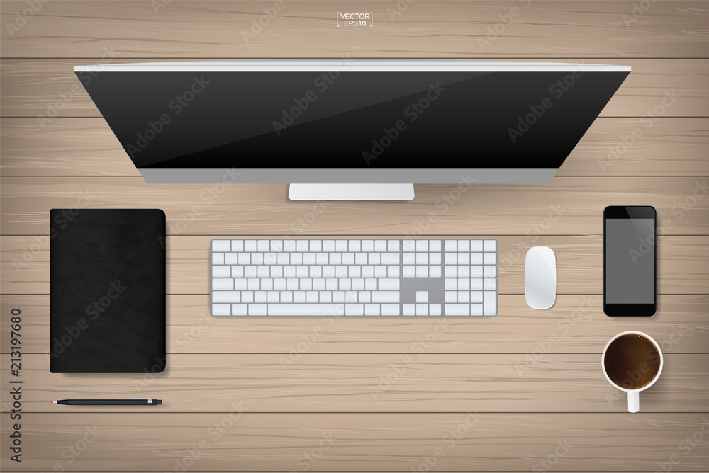 Wood office table with computer and office supplies. Top view of