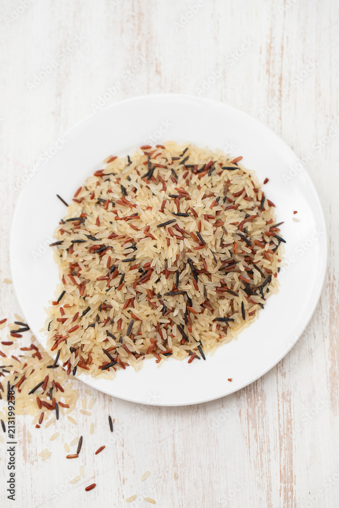white, brown and black rice in white plate white, brown and black rice in white plate