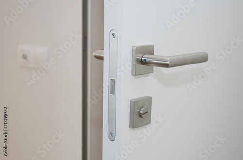 Modern home interior door  with metal handle and lock © bildlove