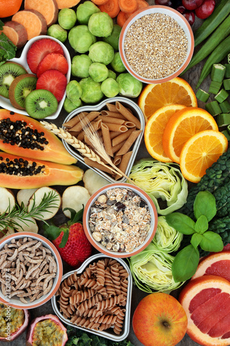 High dietary fibre health food concept with fresh fruit, vegetables, whole wheat pasta and cereals with foods high in antioxidants, anthocyanins, smart carbohydrates and vitamins. Top View.