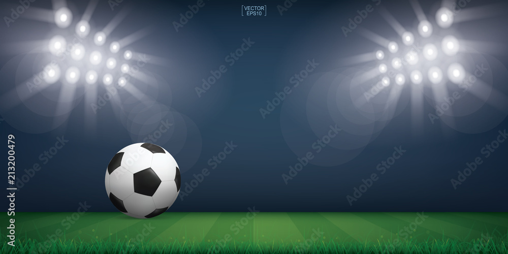 Fototapeta premium Soccer football ball on green grass of soccer field or football field stadium background. Vector.