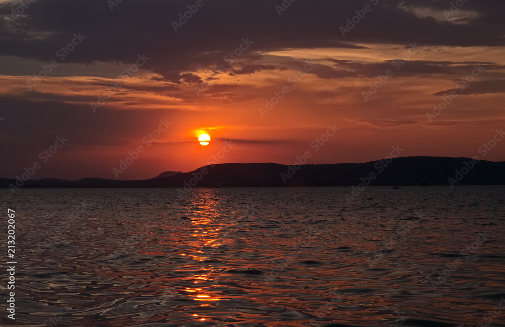 sunset over lake - shining golden bridge, dark tones,