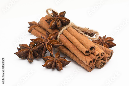 Cinnamon sticks and cardamom on a white background. Aromatic spices.