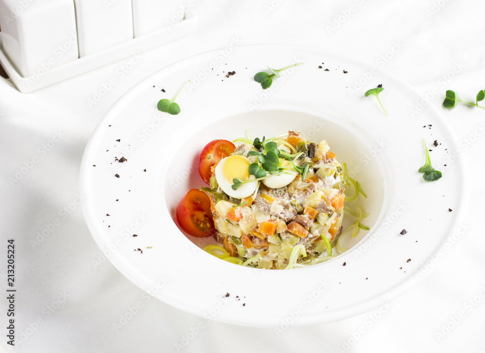 Russian Olivier salad with meat, quail eggs and cherry tomatoes Russian Olivier salad with meat, quail eggs and cherry tomatoes
