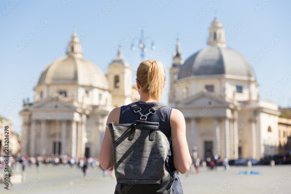 Naklejka premium Female tourist with a fashinable vintage hipster backpack on Piazza del Popolo, People's Square, in Rome, Italy.