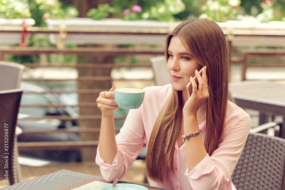 Portrait of beautiful girl using her mobile phone in cafe. Portrait of beautiful girl using her mobile phone in cafe.