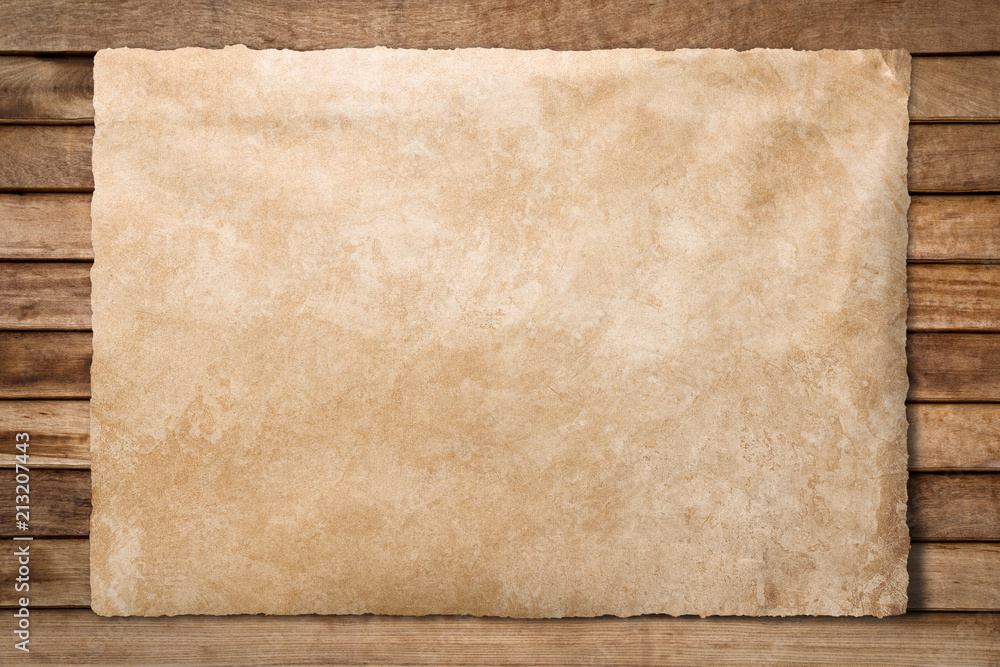 Old paper sheet at wooden background with clipping path