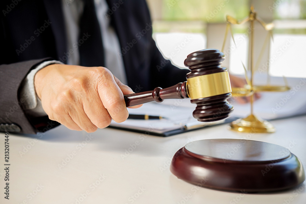 Judge gavel with Justice lawyers having team meeting at law firm in background. Concepts of law. Judge gavel with Justice lawyers having team meeting at law firm in background. Concepts of law.