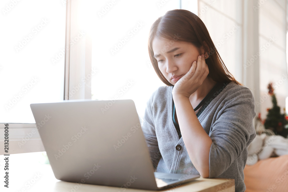 Portrait of a seriously female using laptop computer in cafe. Portrait of a seriously female using laptop computer in cafe.