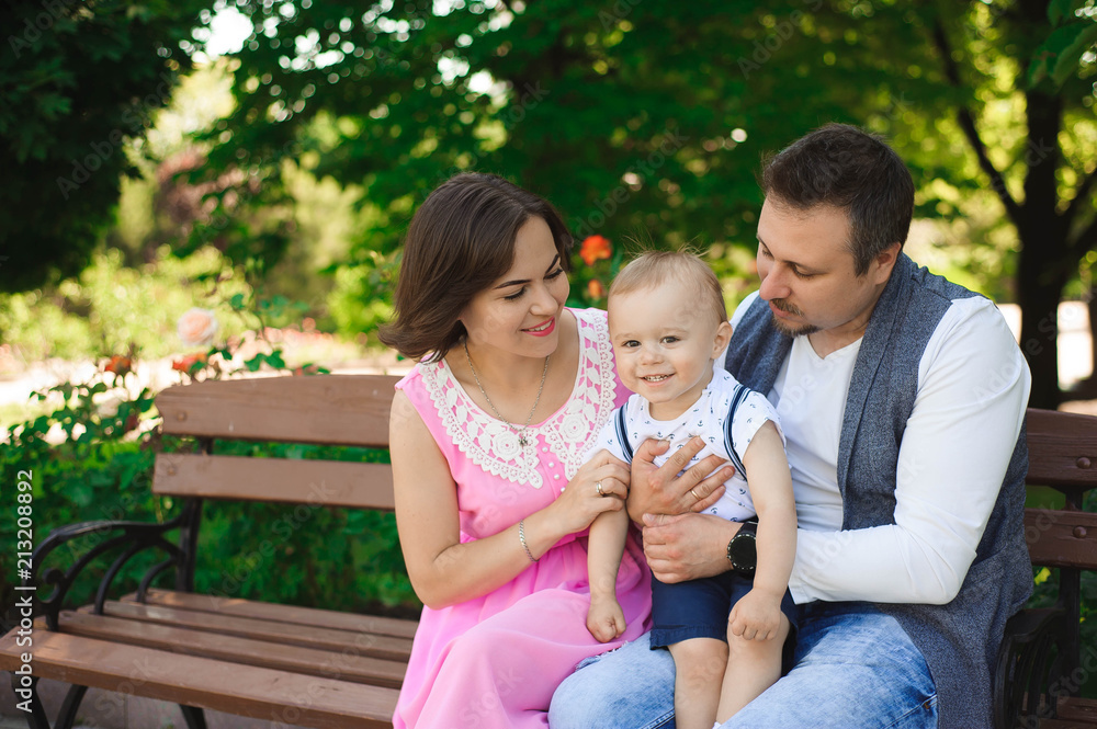 family, parenthood, adoption and people concept - happy mother, father and little boy walking in summer park family, parenthood, adoption and people concept - happy mother, father and little boy walking in summer park
