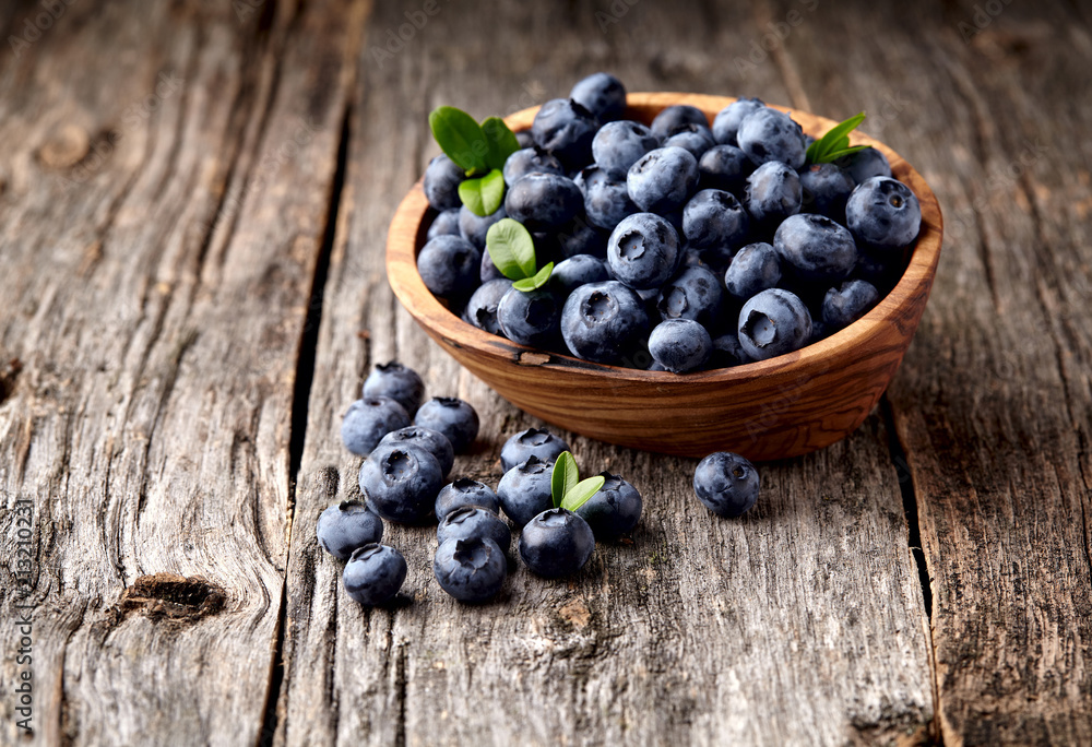 blueberries in bowl on wooden background blueberries in bowl on wooden background