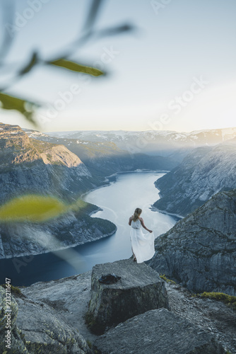 Girl in white dress in the wind in norwegian nature