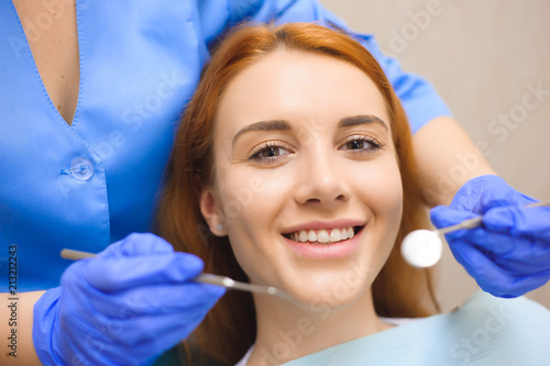 Dentist examining a patient s teeth in the dentist.