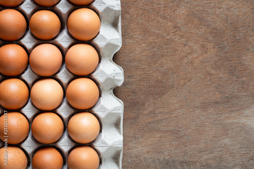 Fresh chicken eggs eggs in paper tray,egg carton on wooden background. Fresh chicken eggs eggs in paper tray,egg carton on wooden background.