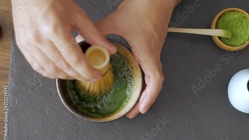 green matcha tea prepearing on stone black table
