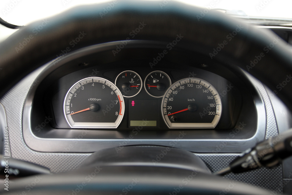 speedometer and tachometer on the dashboard of the car