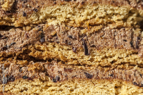 cake with walnuts, prunes and dried apricots on a dark wood background, selective focus