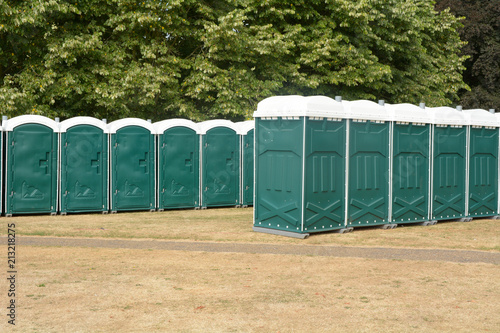 Rows of green portaloos or platic mobile toilets at festival