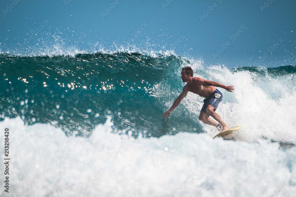 Amateur surfer rides the ocean wave