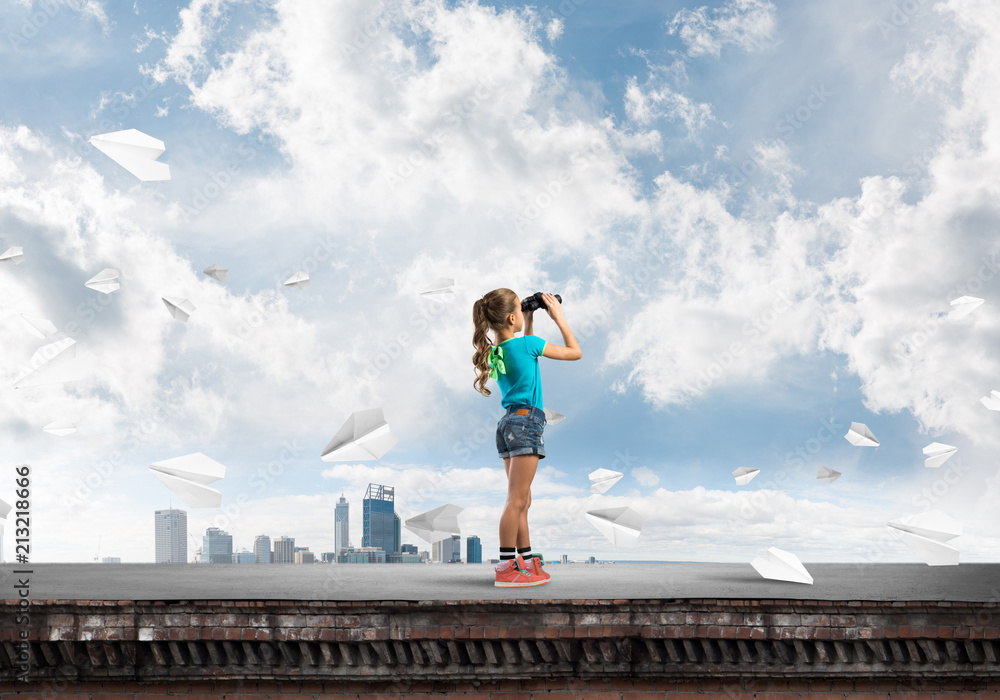 Concept of careless happy childhood with girl of school age looking in future Concept of careless happy childhood with girl of school age looking in future