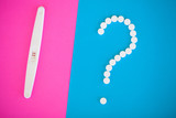 Pregnancy test. The result is positive with two strips and condom with contraceptive on colored background, Birth control pill, safe sex, healthcare concep