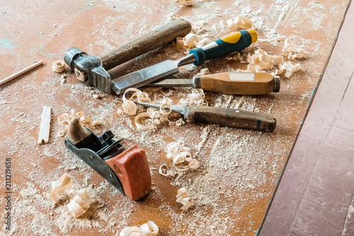 Old traditional carpentry tools with shavings. A hammer and a jointer plane photo