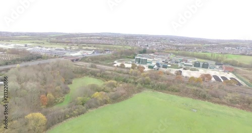 Drone Aerial footage over fields with building nearby