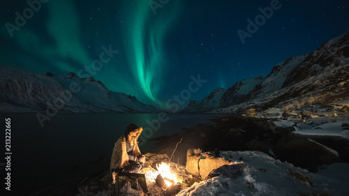 Northern lights in the arctic with a bonfire