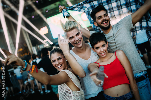 Group of friends having great time on music festival