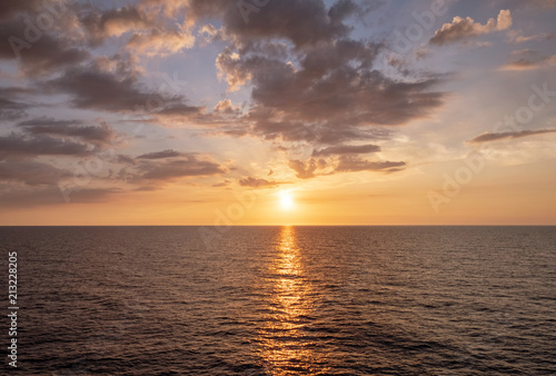Water horizon with sun setting