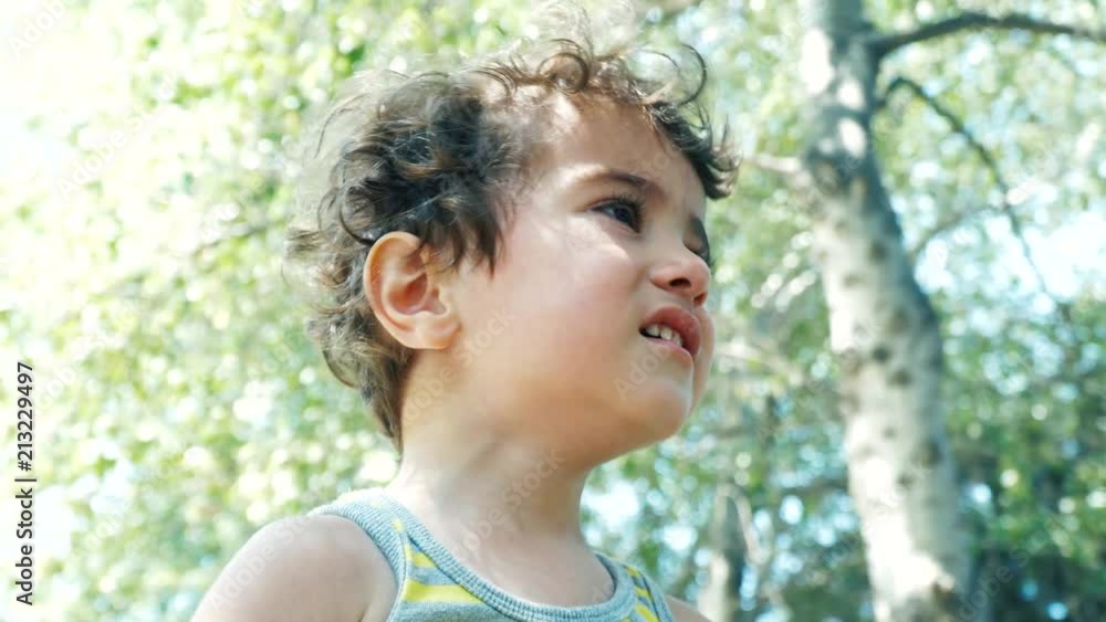 Little boy crying in park in city. Close up. 4K Little boy crying in park in city. Close up. 4K