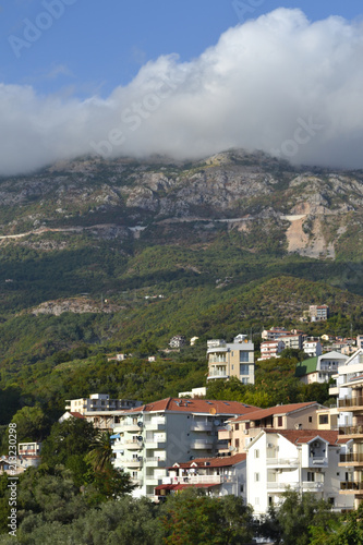 Coastal city at the foot of the mountain. Becici, Montenegro, View of the city and mountains