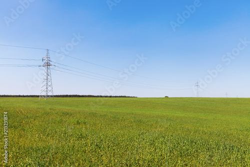 High voltage line among field of grain, vibrant colors
