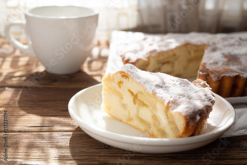 Slice of apple pie on a white plate