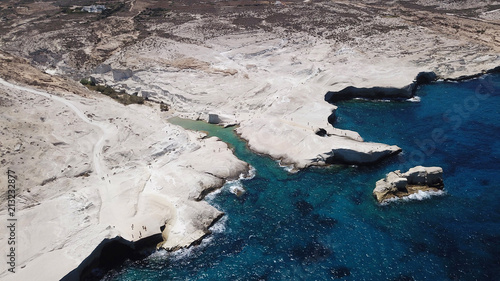 Aerial drone bird's eye view of iconic lunar volcanic white chalk iconic beach and caves of Sarakiniko, Milos island, Cyclades, Greece