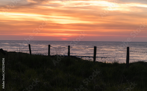 Pentland Sunset.  The sun setting over the Pentland Firth  Caithness  northern Scotland.