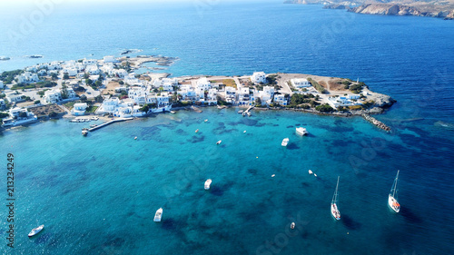 Aerial drone bird's eye view photo of picturesque fishing village of Polonia with traditional fishing boars docked next to island of Kimolos, Milos island, Cyclades, Greece photo