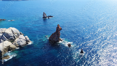 Aerial drone bird's eye view of volcanic rock formations resembling a rabbit near famous beach of Plathiena in island of Milos, Cyclades, Greece