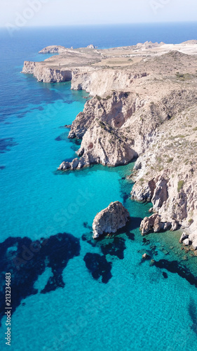 Aerial drone bird's eye view of volcanic and exotic rocky beach with turquoise and sapphire clear waters of Plathiena in island of Milos, Cyclades, Greece