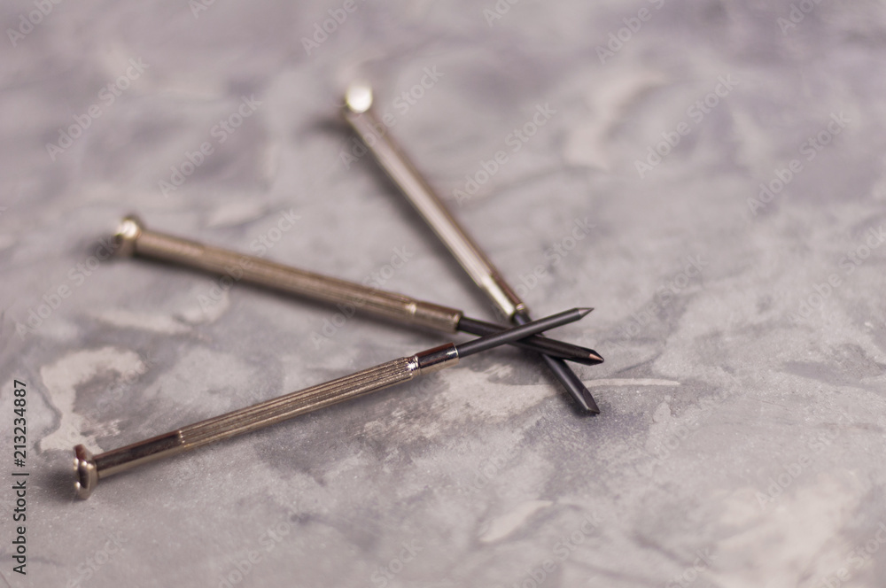 Three new small metal screwdriver on old gray concrete background Three new small metal screwdriver on old gray concrete background