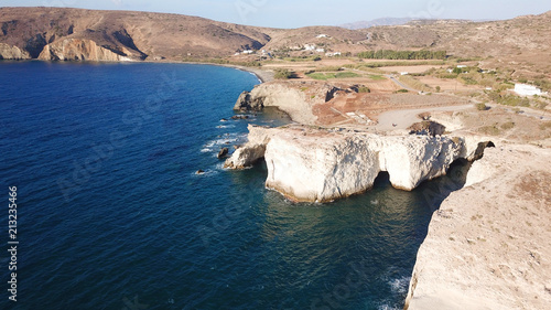 Aerial drone bird's eye view of iconic lunar volcanic white chalk caves and beach of Kapros next to famous caves of Papafragas, Milos island, Cyclades, Greece photo