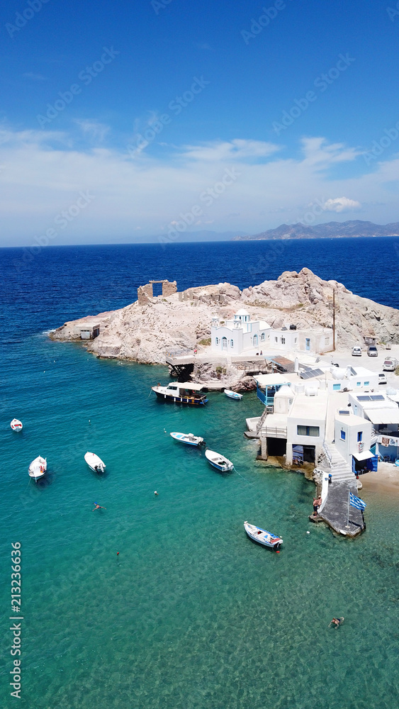 Obraz premium Aerial drone bird's eye view photo of picturesque fishing village of Firopotamos with traditional boat docks called syrmata, small chapel and turquoise water beach, Milos island, Cyclades, Greece