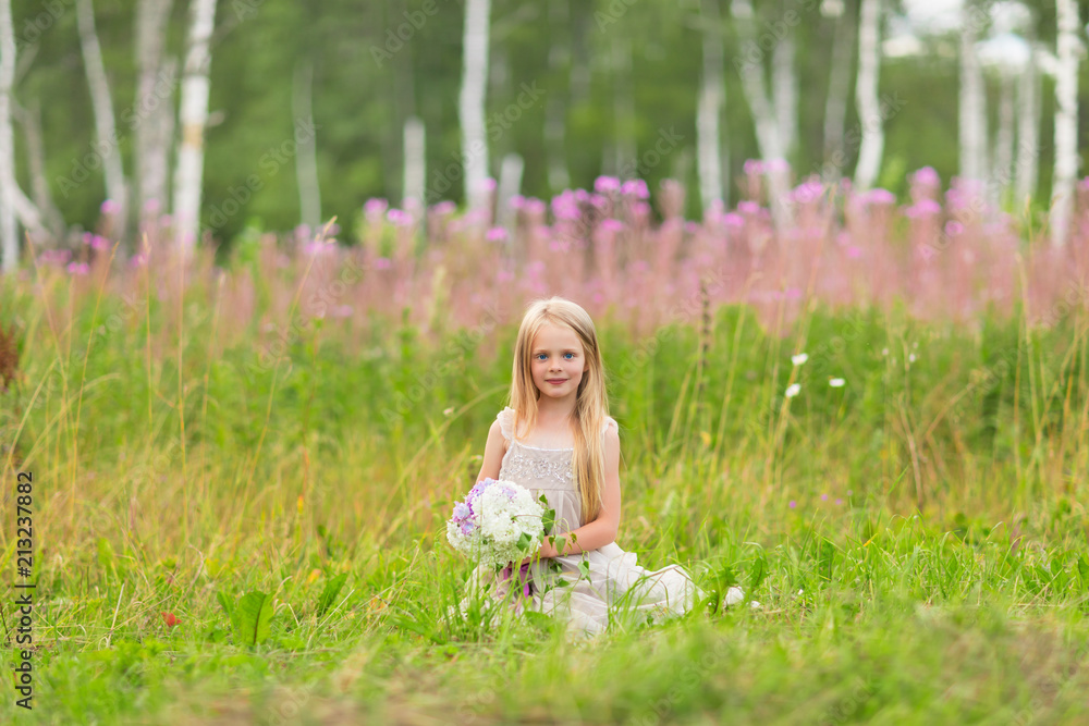 Little blonde girl picking up flowers on meadow Little blonde girl picking up flowers on meadow