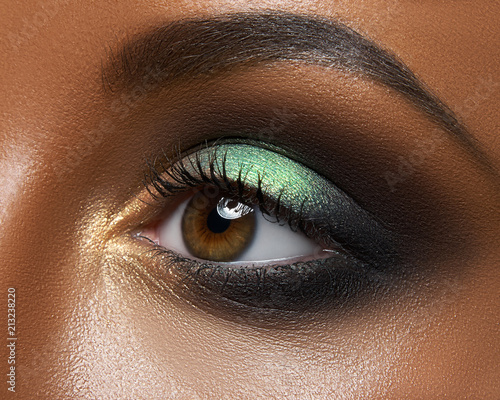 Vászonkép Macro and close-up creative make-up theme: beautiful female eye with green and g