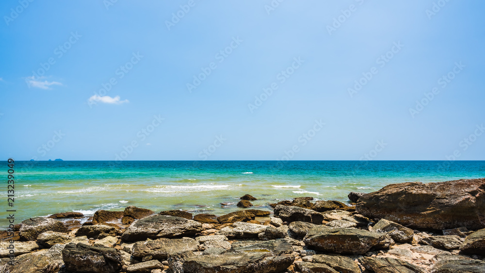 Sea rocks on the beach in sunny day