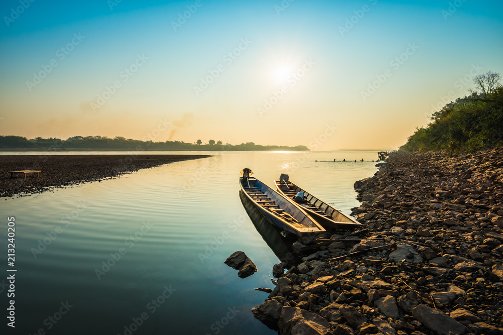 Fishing boat and sunrise in river