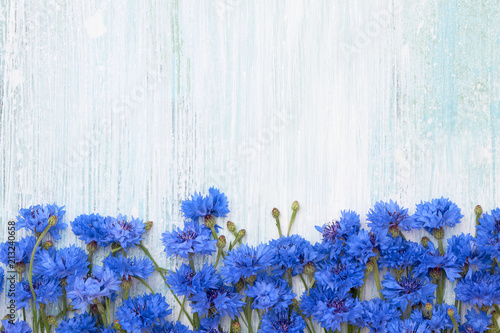 Fototapeta Naklejka Na Ścianę i Meble -  Blue Cornflower border on light blue background. Top view, copy space. Summer background