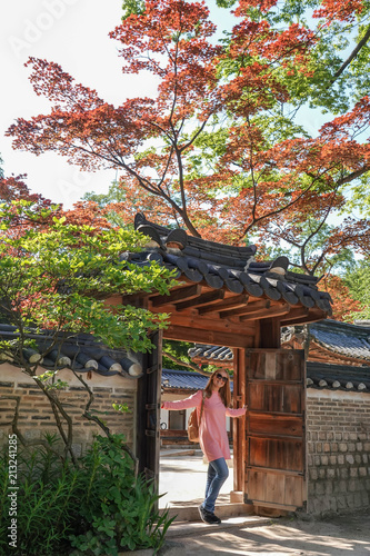 Photography Caucasian Female Tourist Walking and Admiring Korean Architecture