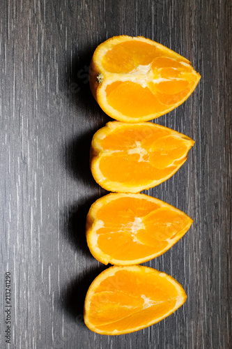 Orange fruit. Orange slice isolate on black wood. photo