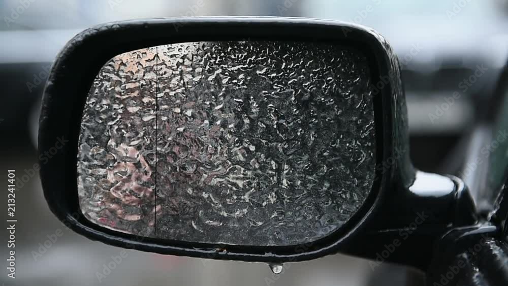 Car mirror covered in ice during freezing rain phenomenon Car mirror covered in ice during freezing rain phenomenon